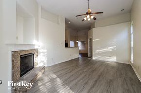 Memphis house for rent - A spacious living room with a fireplace and a ceiling fan.