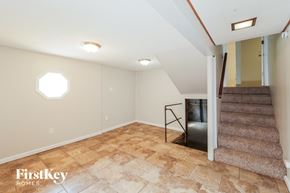 Kansas City house for rent - A room with a staircase and a skylight.