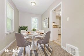 Raytown house for rent - A dining room with a round table and grey chairs.