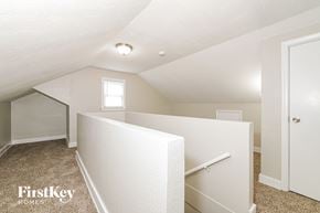 Raytown house for rent - A white bedroom with a window and a door.