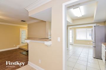 Tampa house for rent - a kitchen and a living room with a refrigerator and a sink