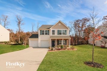 Matthews house for rent - a white house with a yard and a sidewalk
