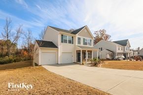 Matthews house for rent - a white house with a driveway in front of it