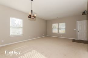 Matthews house for rent - an empty dining room with a door and a chandelier
