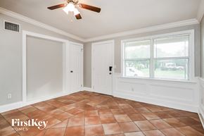 Orlando house for rent - a dining room with a large window and a ceiling fan