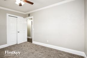 Orlando house for rent - a bedroom with a ceiling fan and a white door