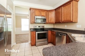 Charlotte house for rent - A kitchen with wooden cabinets and stainless steel appliances.