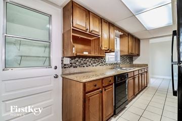 Tampa house for rent - a kitchen with wooden cabinets and a counter top
