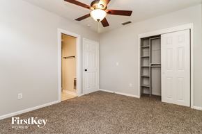 Tampa house for rent - a bedroom with a ceiling fan and a closet