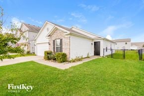 Indianapolis house for rent - A house with a white garage door and a brick wall.