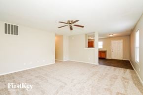 Indianapolis house for rent - A spacious room with a ceiling fan and carpeted floor.