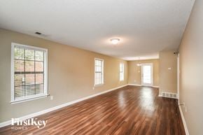 Cordova house for rent - A room with wooden floors and a window with blinds.