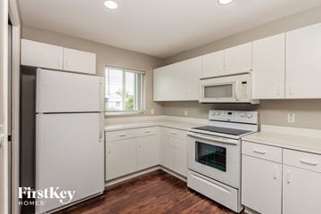 Fort Myers house for rent - a white kitchen with white appliances and white cabinets