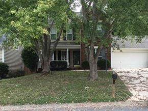 Waxhaw house for rent - a house with trees in front of it and a parking meter