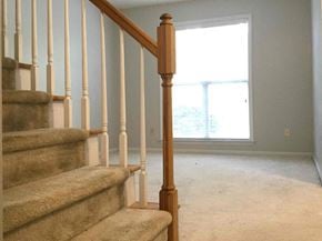 Waxhaw house for rent - a view of a staircase in a house with a window