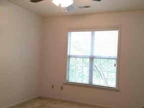 Waxhaw house for rent - a living room with a window and a ceiling fan