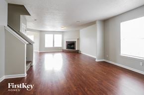 Indianapolis house for rent - an empty living room with wood floors and a fireplace
