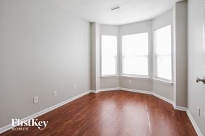 Indianapolis house for rent - a room with a hard wood floor and three windows