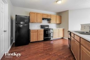 Indianapolis house for rent - a kitchen with wooden cabinets and black appliances