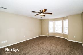 Memphis house for rent - A spacious room with a ceiling fan and carpeted floor.