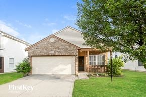 Indianapolis house for rent - a brick house with a white garage door in front of a green lawn