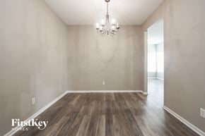 Indianapolis house for rent - the spacious living room with wood floors and a chandelier