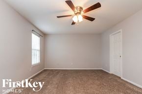 Indianapolis house for rent - A room with a ceiling fan and a window.