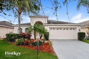 Ruskin house for rent - a white house with a white garage door and a driveway