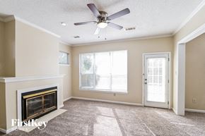 Memphis house for rent - a living room with a fireplace and a ceiling fan