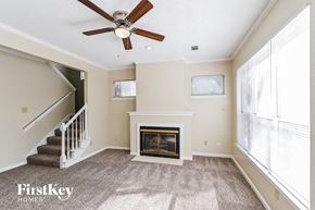 Memphis house for rent - a living room with a fireplace and a ceiling fan