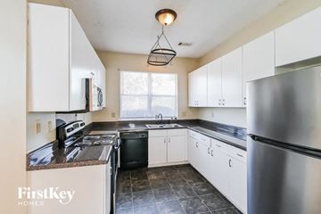 Memphis house for rent - a kitchen with white cabinets and stainless steel appliances