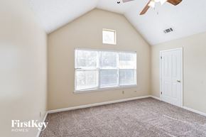 Memphis house for rent - the master bedroom has a large window and carpeted flooring
