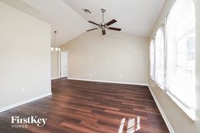 Fort Myers house for rent - a living room with wood flooring and a ceiling fan