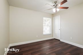 Fort Myers house for rent - a bedroom with hardwood flooring and a ceiling fan