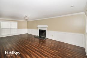 Cordova house for rent - a living room with a fireplace and wooden floors