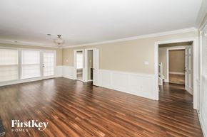 Cordova house for rent - an empty living room with wood floors and white walls