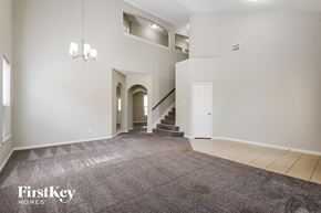 Baytown house for rent - a living room with a carpeted floor and a staircase