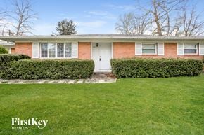 Indianapolis house for rent - A house with a white door and a hedge in front.