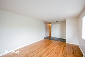 Indianapolis house for rent - A room with wooden floors and white walls.