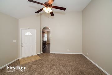 Mccalla house for rent - a living room with a ceiling fan and a carpet