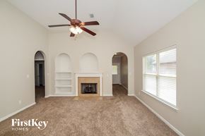 Mccalla house for rent - a living room with a fireplace and a ceiling fan