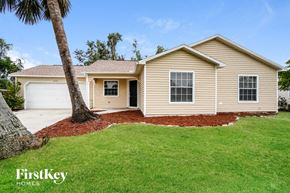 Fort Myers house for rent - A house with a palm tree in front of it.