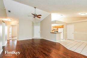 Fort Myers house for rent - A spacious room with a wooden floor and a ceiling fan.