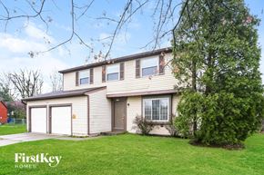 Indianapolis house for rent - the front of a house with a yard and a garage