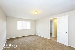 Indianapolis house for rent - a bedroom with carpet and a door to a closet