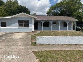 Tampa house for rent - A white building with a Firstkey logo in the bottom left corner.