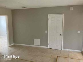 Tampa house for rent - A room with a white door and a tiled floor.