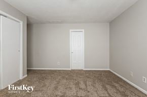 Indianapolis house for rent - a bedroom with carpet and a white door