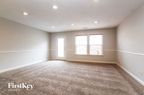 Indianapolis house for rent - A spacious room with a carpeted floor and two windows.