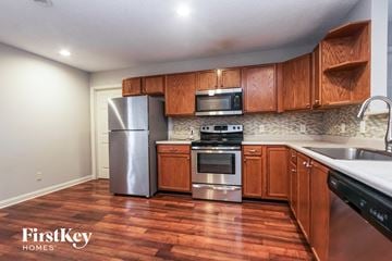 Indianapolis house for rent - A kitchen with wooden cabinets and a stainless steel refrigerator.
